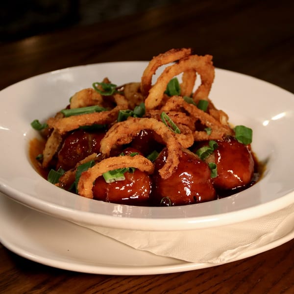American meatballs in a rich sauce, topped with crispy fried onions and green scallions.